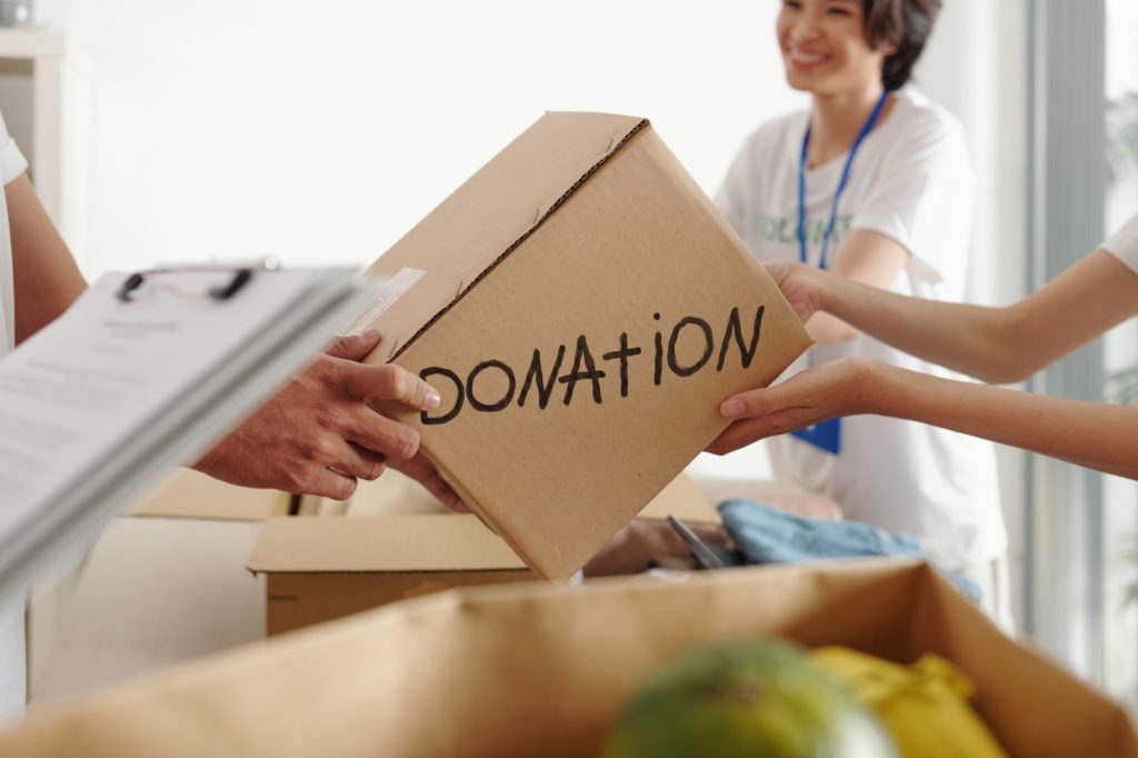 Man donating box of groceries